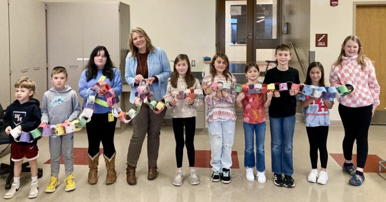 students at westmont hilltop school holding a chain of paper loops