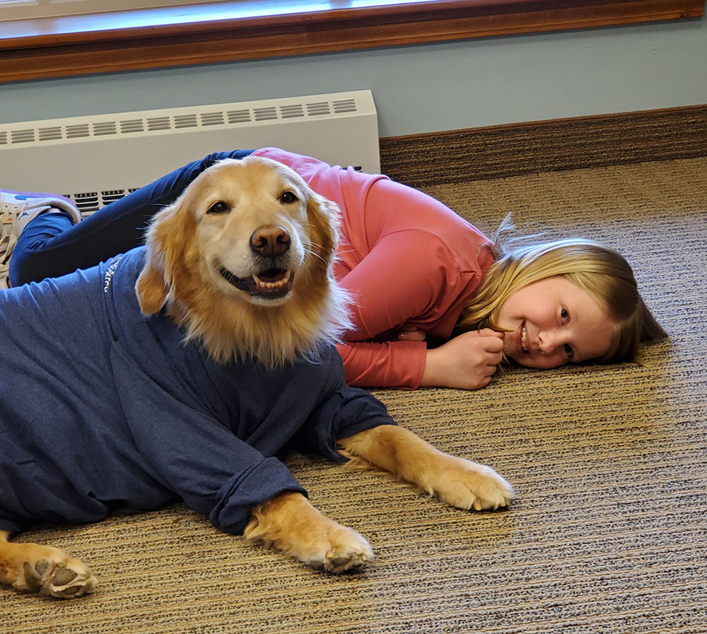 child smiling with a healing patch therapy dog