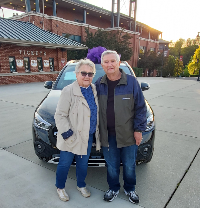 the 2023 mercedes moment winners posing with their new car